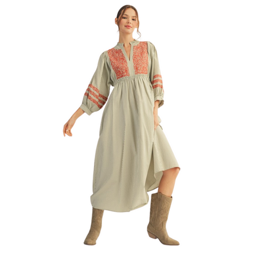 This Jodifl embroidered midi dress features an elegant olive color complemented by subtle striped designs. Its 3/4 length sleeves add a refined touch, making it ideal for both casual and semi-formal occasions. The midi length offers flattering coverage, while the embroidery enhances its sophisticated style. Perfect for those seeking a blend of comfort and timeless fashion.