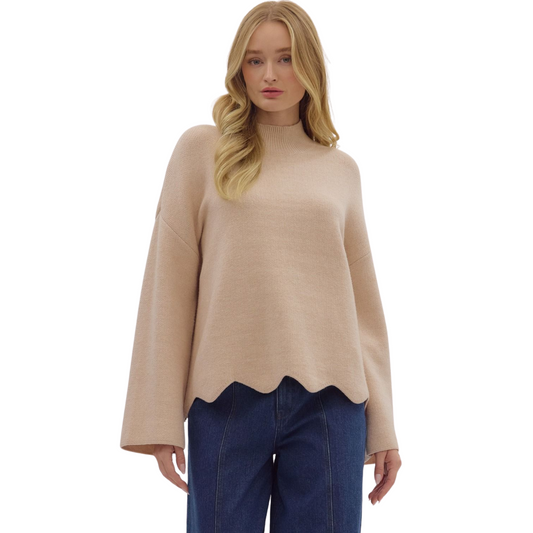 This Entro solid scalloped hem top in oatmeal offers a sophisticated take on casual wear. Featuring a ribbed mock neck and scalloped hem, this medium-weight knit pullover is unlined and non-sheer, providing comfortable coverage and effortless layering. Its refined silhouette makes it a versatile piece suitable for both professional and relaxed settings.