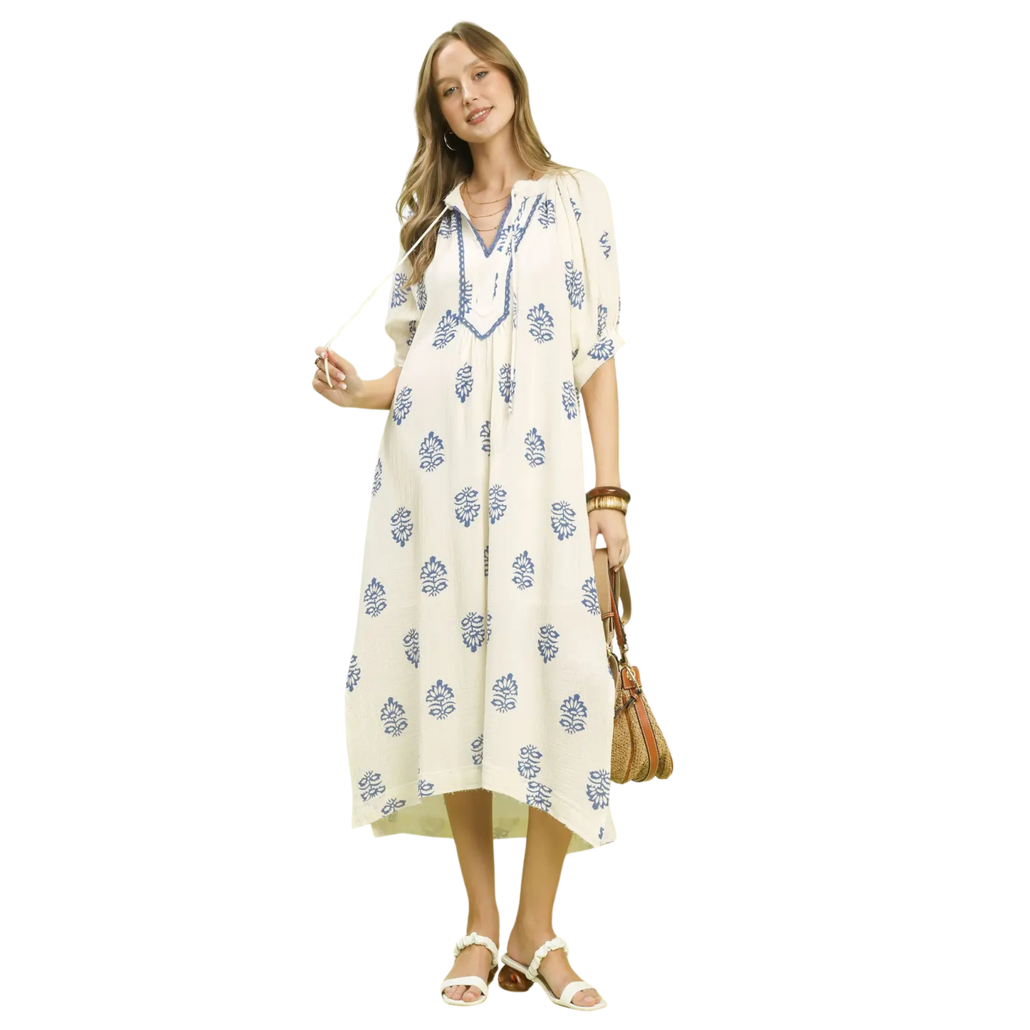 This Umgee midi dress combines understated elegance with artistic design. The off-white canvas showcases a striking abstract print that adds visual interest without overwhelming your look. Cut with a graceful V-neckline and midi length, it strikes the perfect balance between sophistication and wearability. The thoughtful silhouette flatters various body types while maintaining a polished aesthetic. 