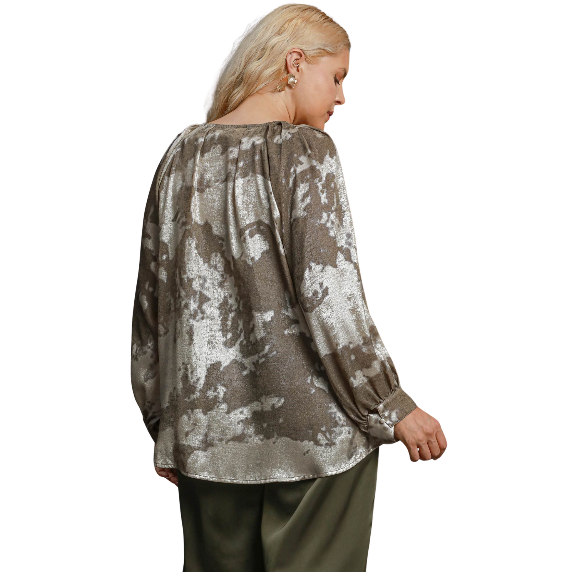 The Umgee Metallic V-Notched Top features a stylish v-neck and abstract design in a chic taupe color. Its unique design blends fashion and comfort, making it a must-have addition to any wardrobe. Elevate your look with this effortlessly trendy top.