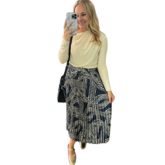 This navy accordion midi skirt features elegant pleats and a sophisticated abstract print, merging classic structure with modern design. Its midi length provides versatile styling options, suitable for both professional and casual settings. Crafted to maintain shape and flow, it offers a flattering silhouette that enhances movement while ensuring comfort throughout the day. Perfect for those seeking a refined yet distinctive addition to their wardrobe.