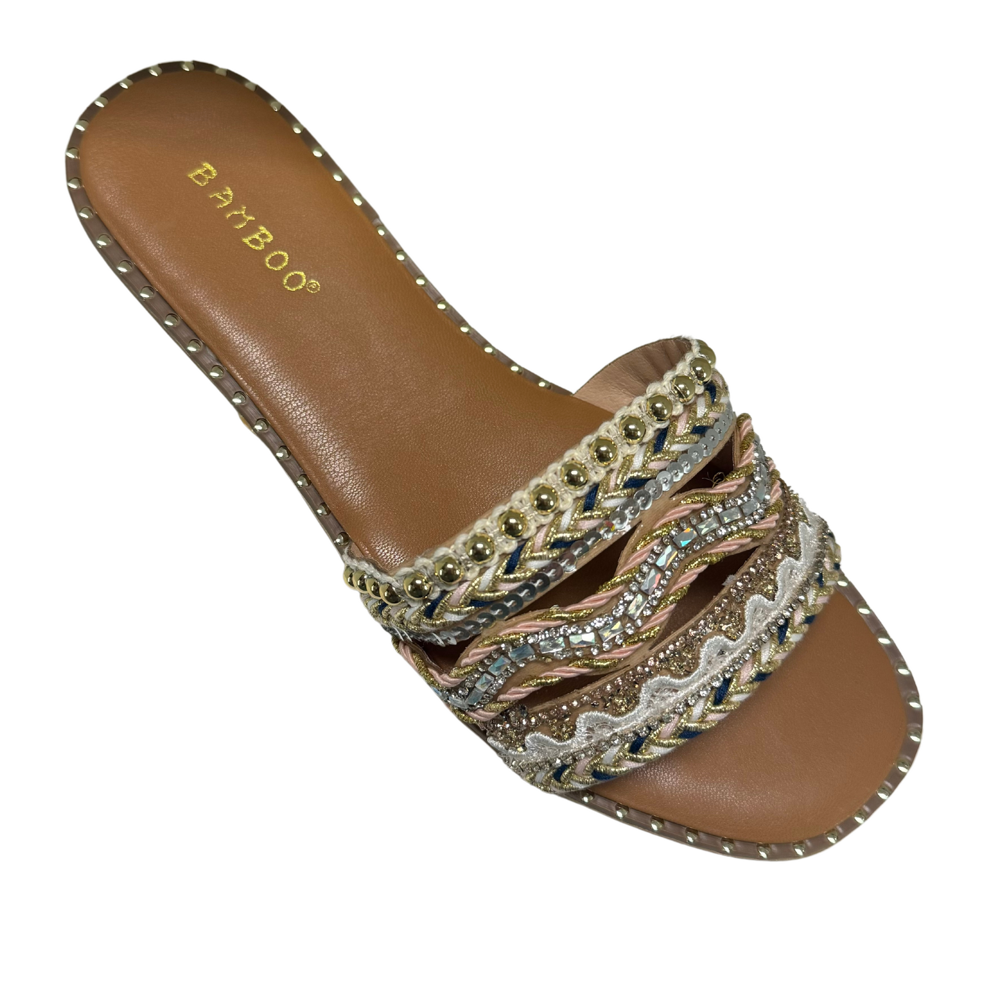 Introducing the Alta-83, a fashionable and versatile flat sandal featuring a stunning rhinestone accent and elegant gold detailing. The slide on design ensures a comfortable and effortless fit. Elevate your summer style with the Alta-83.