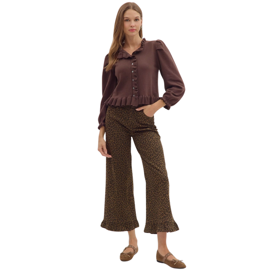 These cropped wide-leg pants from Entro fuse bold animal print with a sophisticated brown palette, creating a striking statement piece. The ruffle hem adds delicate movement and an elevated feminine touch, while the high-quality fabric ensures comfort and durability. Perfect for styling with both casual and dressy tops, they offer versatile wear for a confident, fashion-forward look.