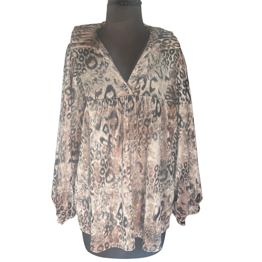 Our Animal Print V-Neck Top features a comfortable and stylish v-neck design, perfect for any occasion. The collared neckline adds a touch of sophistication, while the unique brown and black combo adds a bold statement to your wardrobe. With long sleeves, you'll stay warm and fashionable all day long.
