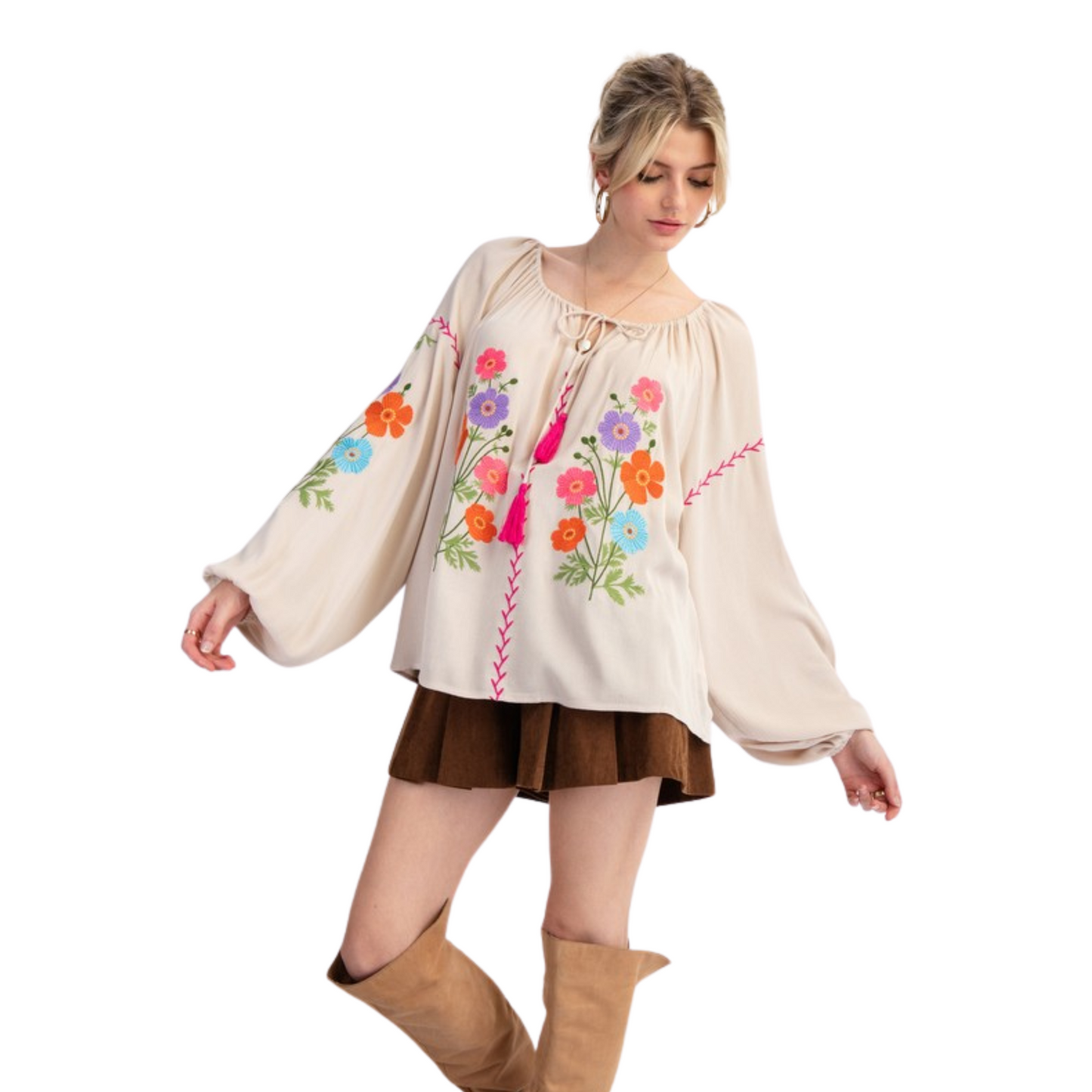 Expertly crafted from lightweight rayon gauze, this embroidered babydoll tunic features long bubble sleeves, a rounded neckline with adjustable tassel tie, ruched detailing, dropped shoulders, and elastic cuffs. The relaxed and loose fit provides comfort and style. Perfect for any casual or dressed-up occasion.