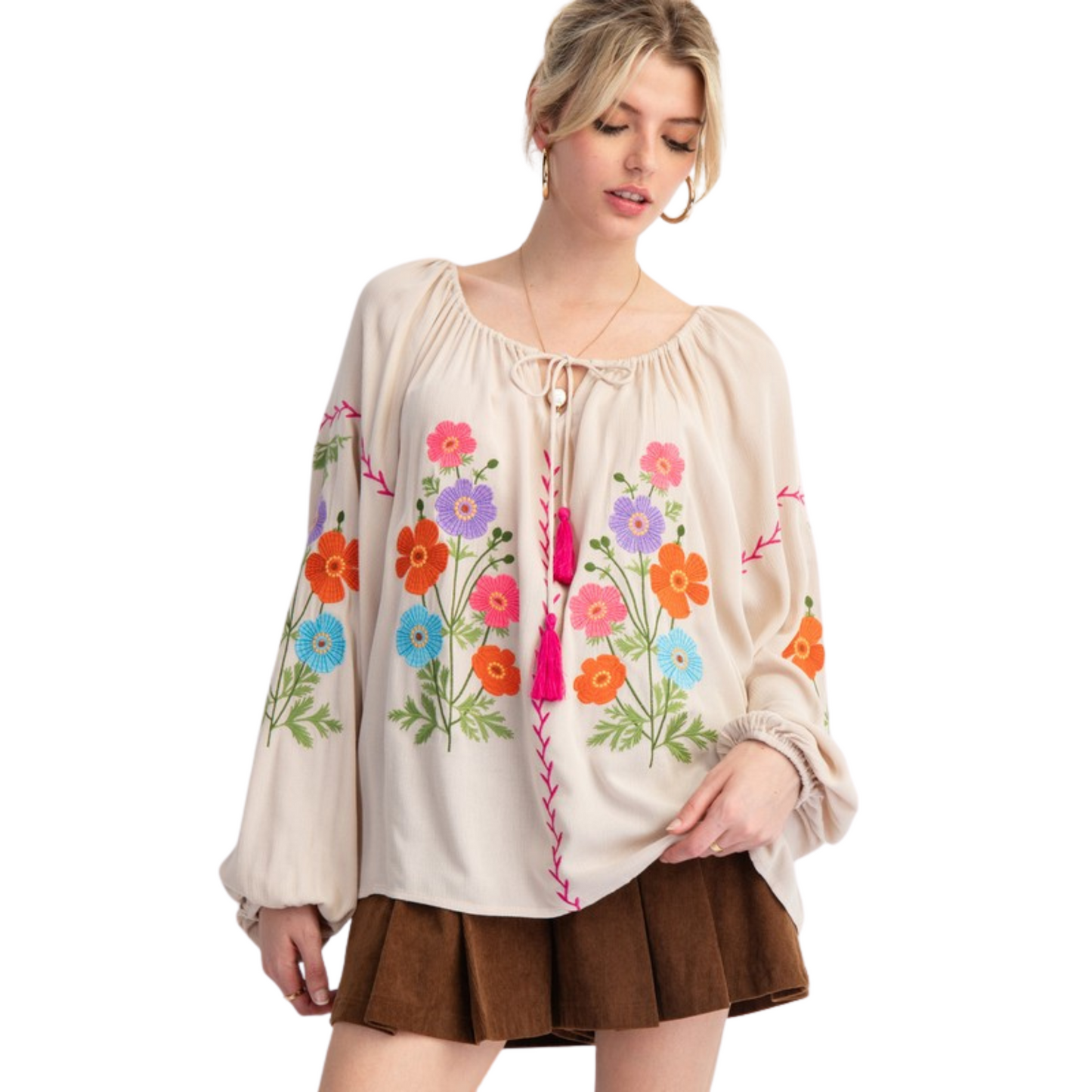 Expertly crafted from lightweight rayon gauze, this embroidered babydoll tunic features long bubble sleeves, a rounded neckline with adjustable tassel tie, ruched detailing, dropped shoulders, and elastic cuffs. The relaxed and loose fit provides comfort and style. Perfect for any casual or dressed-up occasion.