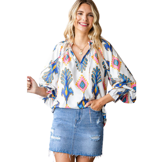 This Balloon Sleeve Woven Top offers a chic ethnic print with a relaxed fit. A ruffled split neckline, drawstring, and 3/4 balloon sleeves add a touch of style. The smocked cuffs provide a comfortable fit. Upgrade your wardrobe with this unique top.