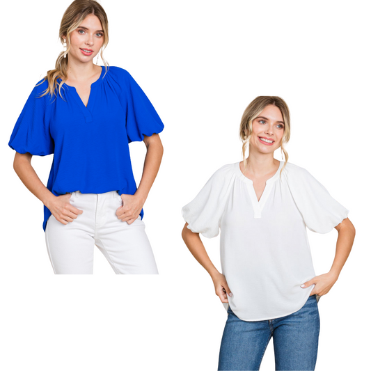 The Balloon Sleeve Top features a v neck design and trendy bubble sleeves. With a sophisticated and versatile style, this top is perfect for any occasion. Enhance your wardrobe with this must-have fashion piece. Available in off white or royal blue.