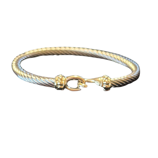This Perdido Gems bangle bracelet showcases a refined two-tone design, merging warm gold with cool silver for a versatile accessory that complements any wardrobe. The contrasting metals create visual depth while maintaining a cohesive, sophisticated aesthetic. Expertly finished with a smooth, polished surface, this piece delivers both durability and timeless appeal. Whether worn alone or layered with other bracelets, it serves as a foundational element in curated jewelry collections. 