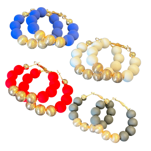 Make a lasting impression with these Large Beaded Hoop Earrings. Crafted with intricately detailed red, black, white, and blue beads with gold accents, these earrings are sure to add an eye-catching element to any outfit.
