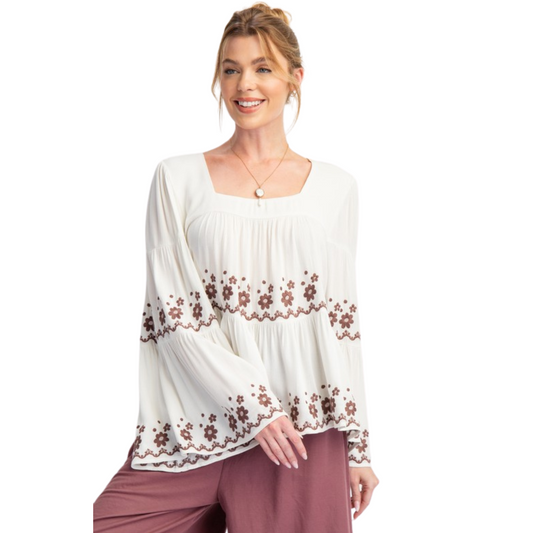 Experience effortless style in our Bell Sleeve Embroidered Tiered Top. The ivory color and flower pattern embroidery detailing add a touch of elegance, while the square neckline and relaxed fit provide comfort. The lightweight fabrication and flowy silhouette make this top perfect for any occasion. Plus size and long bell sleeves make it a versatile choice.