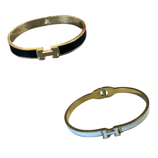 This Hermes Dupe Cuff Bangle adds a touch of elegance to any outfit with its beautifully crafted gold and white or gold and black  design. Made in the style of the renowned fashion brand, this cuff bangle is a versatile accessory that can be worn for both casual and formal occasions. The perfect addition to any jewelry collection.