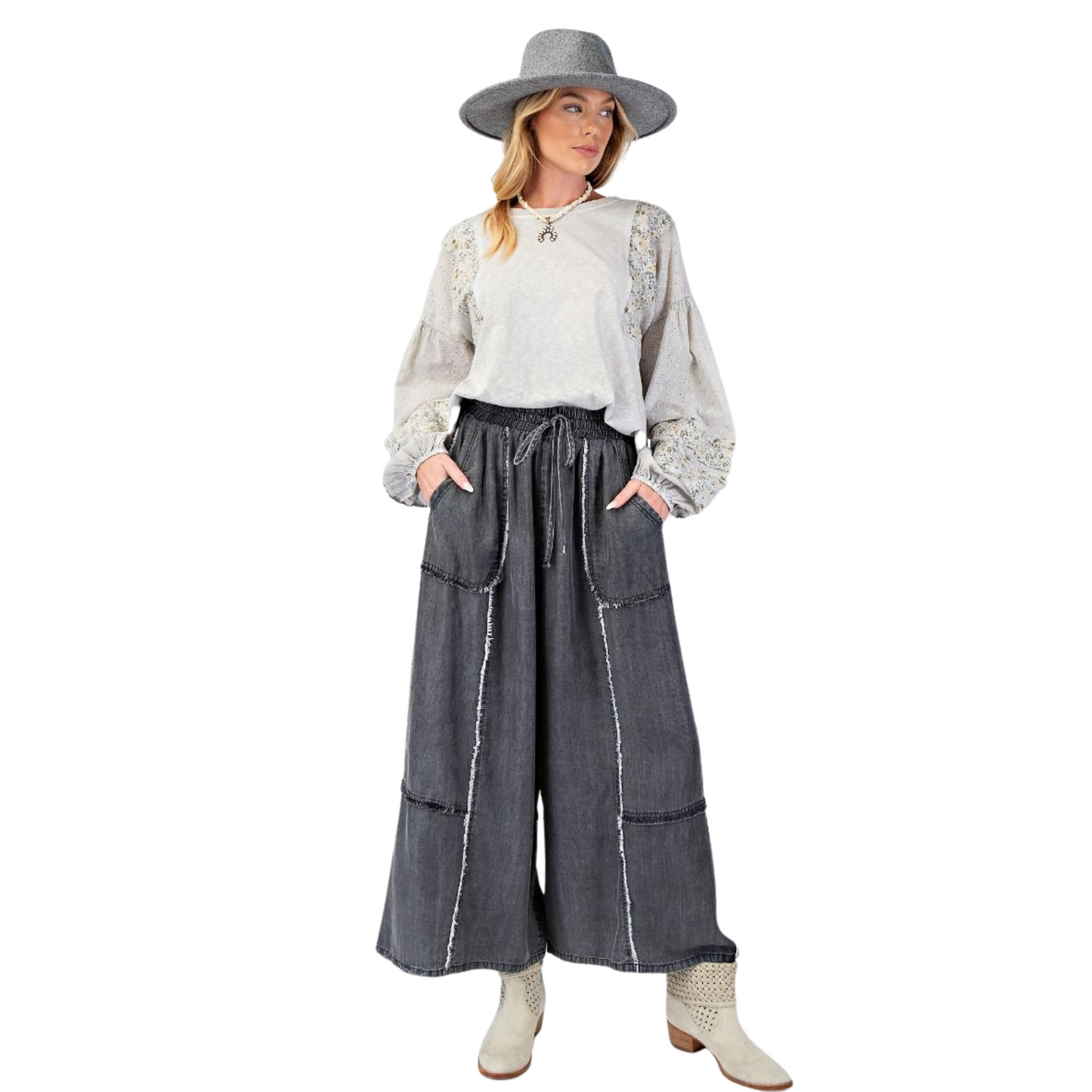 Update your wardrobe with our Chambray Palazzo Pants! These washed denim pants offer a relaxed and loose fit, perfect for a comfortable and stylish look. The smocked waistband with an adjustable tie provides a flattering silhouette while the frayed panel detailing adds a touch of uniqueness. With functional front pockets and a wide leg design, these pants are both practical and chic. Available in regular and plus size.&nbsp;