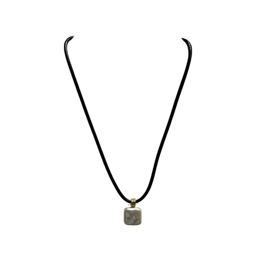 Elevate your everyday style with this refined black cord necklace from Perdido Gems. Featuring a striking silver square pendant, this short necklace delivers understated sophistication with a modern edge. The sleek black cord provides a versatile foundation that complements any wardrobe, while the geometric silver accent adds visual interest and contemporary flair. Perfect for layering or wearing solo, this piece bridges casual and polished aesthetics effortlessly.