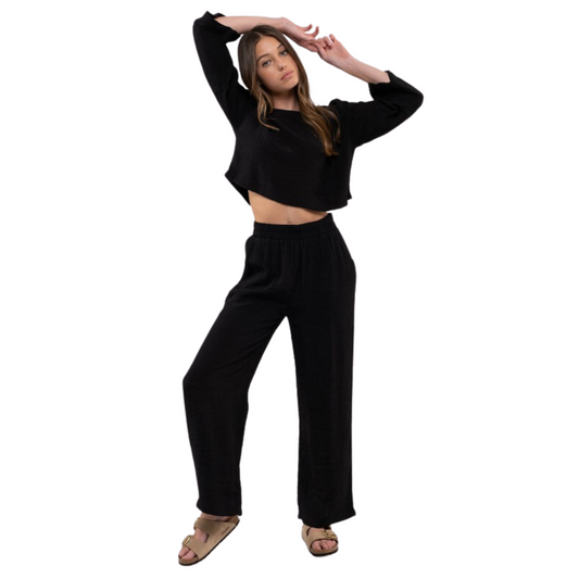 This Extended Shoulder Cropped Top is the perfect balance between modern and classic fashion. It features a wide U neckline, extended shoulders, and long sleeves for a modest look. The cropped body is lightweight and comfortable, making it the ideal choice for everyday fashion. Available in black.