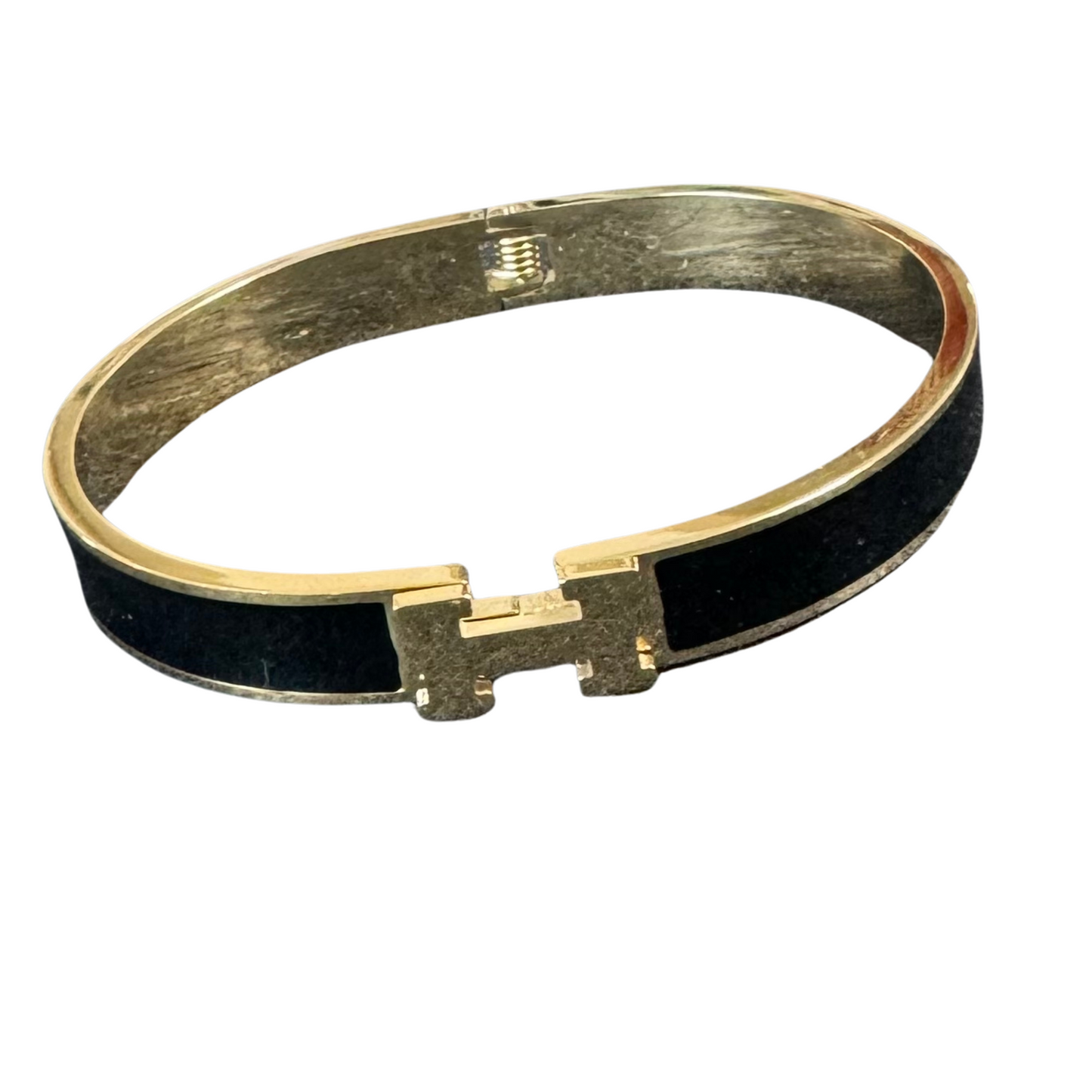 This Hermes Dupe Cuff Bangle adds a touch of elegance to any outfit with its beautifully crafted  gold and black  design. Made in the style of the renowned fashion brand, this cuff bangle is a versatile accessory that can be worn for both casual and formal occasions. The perfect addition to any jewelry collection.