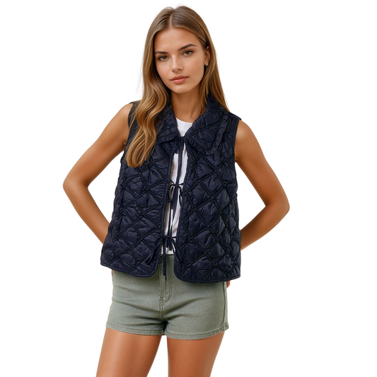 Elevate your layering game with the Doe and Rae Ruffled Quilted Vest. This black oversized piece features a distinctive quilted texture and a structured collar for added sophistication. Its convenient tie closure allows for an adjustable fit, combining style with comfort. Perfect for transitional weather, this vest offers versatility while enhancing your outerwear collection with a refined, expert touch.