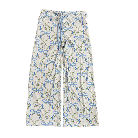 Bows &amp; Blossoms Pajama Pants by Amanda Blu combine comfort with thoughtful design. These white sleep pants feature a charming bows and blossoms print accented in blue, creating an elegant yet relaxed aesthetic. The adjustable drawstring waist ensures a customized fit for all-night comfort. Crafted for quality rest, these pants deliver the softness and breathability you need for uninterrupted sleep while maintaining a polished appearance.