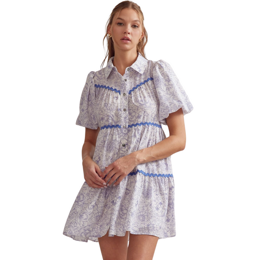 Expertly crafted with a flattering collared neckline and bubble sleeves, this Floral Button Up Mini Dress adds a touch of sophistication to any wardrobe. The lightweight, non-sheer material features a delicate floral print and charming trim details, making it a versatile addition to your spring and summer collection. Perfect for any occasion, this dress is sure to become a favorite.