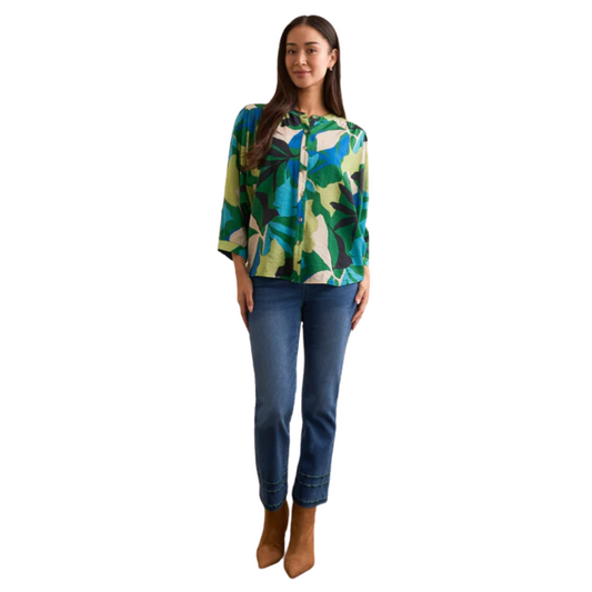 This Flowy Dolman Sleeve Blouse features a vibrant abstract print in a dynamic blue and green mix, reflecting the distinctive style of Tribal brand. Designed with a button-up top for easy wear, its relaxed dolman sleeves offer comfort and fluid movement. Perfect for elevating casual ensembles with a touch of artistic flair and expert craftsmanship.