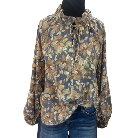 This elegant dusty blue top from GiGio features a delicate floral print that enhances its sophisticated design. The ruffle collar adds a refined touch, while its long balloon sleeves provide both comfort and style. A tie-front detail completes the look, offering a flattering fit perfect for elevated casual or professional settings.