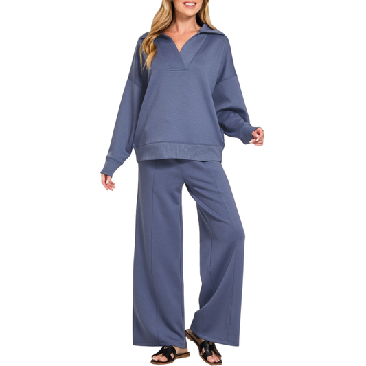Zenana's scuba pullover and pants set combines comfort with contemporary style. The long-sleeved pullover features a classic blue collar design, while the matching pants complete a coordinated look. Crafted from quality materials, this set offers versatility for casual wear or layering. Perfect for those seeking effortless coordination without compromising on fit or fabric quality.