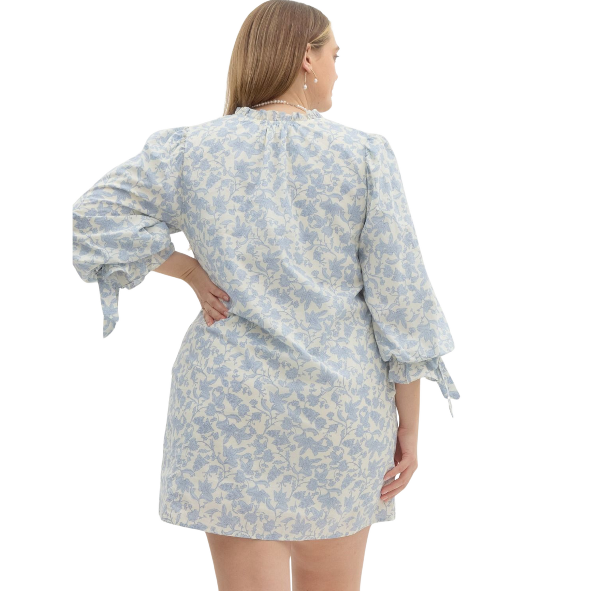 This Floral Mini Dress is the perfect addition to your wardrobe, featuring a beautiful floral print and ¾ puff sleeves with an elasticated opening accented with fixed ribbon. With convenient side pockets and a lightweight, non-sheer material, this dress is both stylish and functional. Stay comfortable and chic in this lined, woven mini dress.