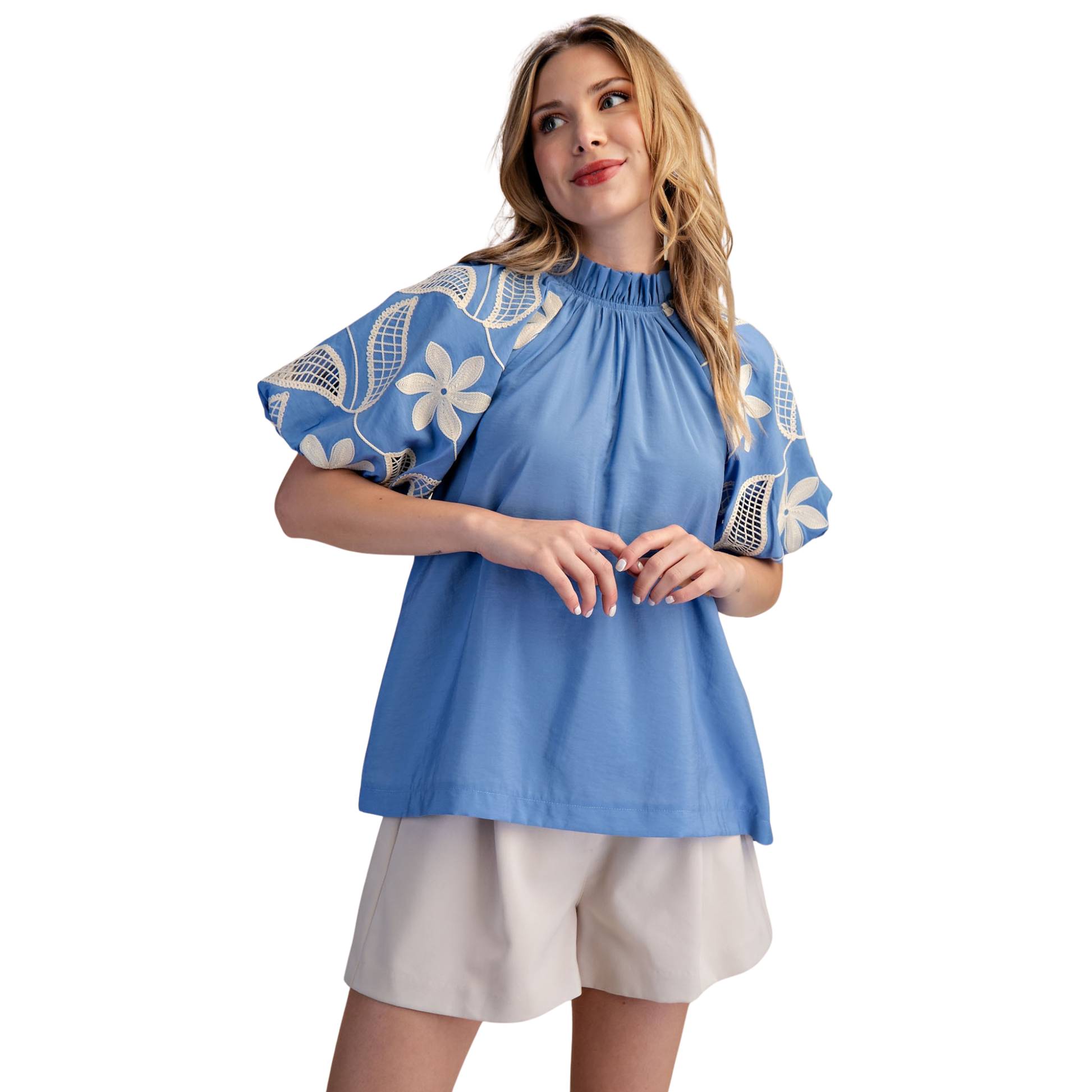 Elevate your wardrobe with this stunning Ruffle Neck Bubble Sleeve Top by Glam. Featuring a charming ruffle neckline and playful puff sleeves, this short-sleeve top combines elegance with a touch of whimsy. The delicate floral design adorning the sleeves adds a feminine, eye-catching detail that transitions seamlessly from casual to dressy occasions. Crafted in a rich blue hue, this piece is perfect for anyone seeking a statement top that balances sophistication with fun, everyday style.