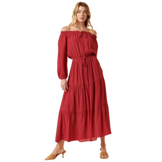 This Off-the-Shoulder Boho Maxi Dress is crafted from a lightweight woven fabric, making it perfect for the warmer months. The dress is detailed with a flattering off-shoulder elastic tunnel neckline and long sleeves. A waist tie front detail adds a flattering finish to the silhouette. A dry rose color completes the look.