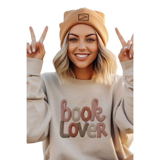 Elevate your casual wardrobe with this bone-colored long sleeve sweatshirt, expertly crafted by Carmelo brand. Featuring a thoughtfully designed book lover graphic, it's the perfect piece for readers who want to express their passion for literature in style. The comfortable fit and quality construction make it ideal for layering or wearing solo during cooler months. A versatile staple that speaks to your intellectual interests while delivering everyday wearability.