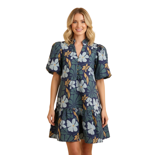 Embrace effortless elegance with this navy mini dress from Hemish. Featuring delicate botanical prints that add visual interest, the flattering V-neckline pairs beautifully with dramatic puff sleeves for a modern, romantic silhouette. The tiered construction creates movement and dimension, perfect for transitional seasons. A versatile piece that works from day to evening.
