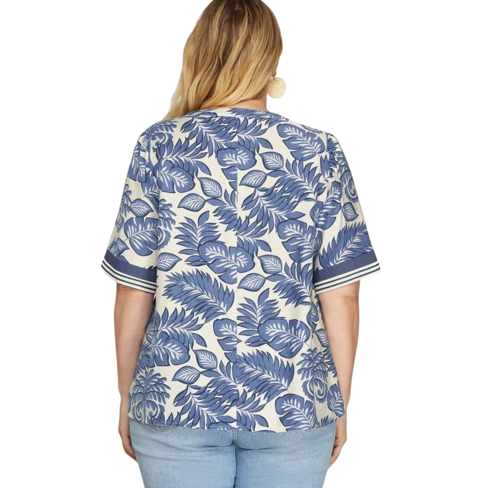 Elevate your everyday wardrobe with this stunning Woven Print Top from She+Sky. Featuring a serene botanical print in rich blue tones, this piece brings natural elegance to any outfit. The flattering V-neckline creates a refined silhouette while the quality woven fabric ensures comfort and durability. Perfect for layering or wearing solo, this versatile top transitions seamlessly from casual days to dressed-up occasions. 