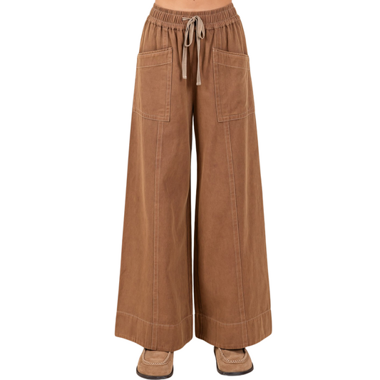Mineral Wash Twill Pants in a rich cocoa color combine comfort and style with expert craftsmanship. Featuring a wide-leg cut and a soft twill fabric, they offer a relaxed yet polished fit. The elastic waist and adjustable drawstring ensure a customizable, secure fit for all-day wear. Perfect for versatile wardrobe layering, these Mittoshop pants bring effortless sophistication to casual and refined looks alike.