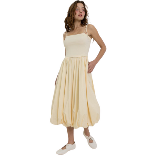 This buttermilk-colored midi dress by Heyson boasts spaghetti tie straps and a trendy bubble hem. Chic and versatile, this dress is perfect for any occasion. Made with high-quality materials, you can trust in the Heyson brand for long-lasting style.