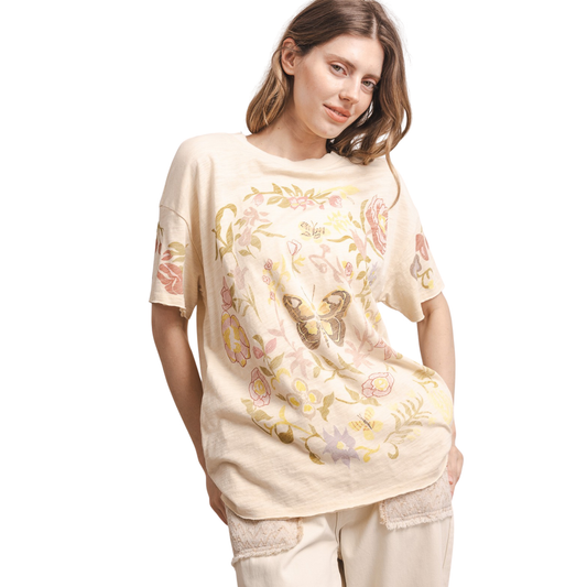 Embrace effortless style with this charming Butterfly In Garden Tee from Blue Velvet. Crafted in a warm tan hue, this short-sleeve tee features a delicate butterfly graphic that brings a touch of nature-inspired elegance to your everyday wardrobe. Perfect for casual outings, weekend adventures, or relaxed layering, this versatile piece pairs beautifully with jeans, shorts, or skirts. Soft, comfortable, and timeless—a wardrobe essential that celebrates natural beauty.