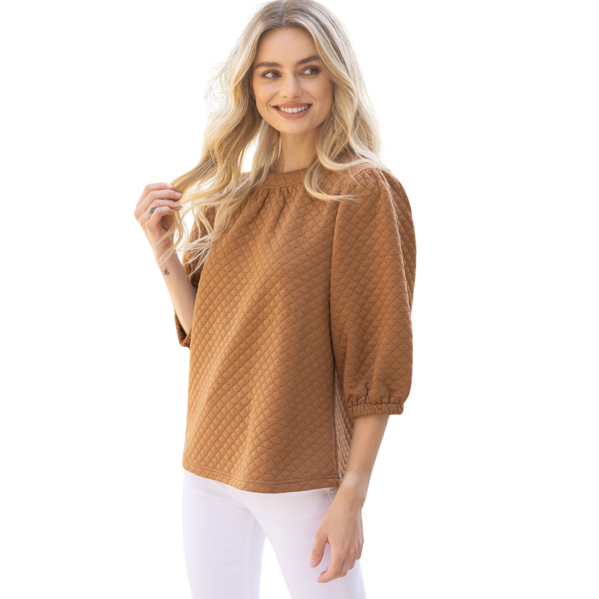 This quilted knit top features a round neckline with band and back neck button and elastic loop closure, paired with half puff sleeves for a fashionable and comfortable fit. In a warm camel color, this top is perfect for adding texture and style to any outfit.