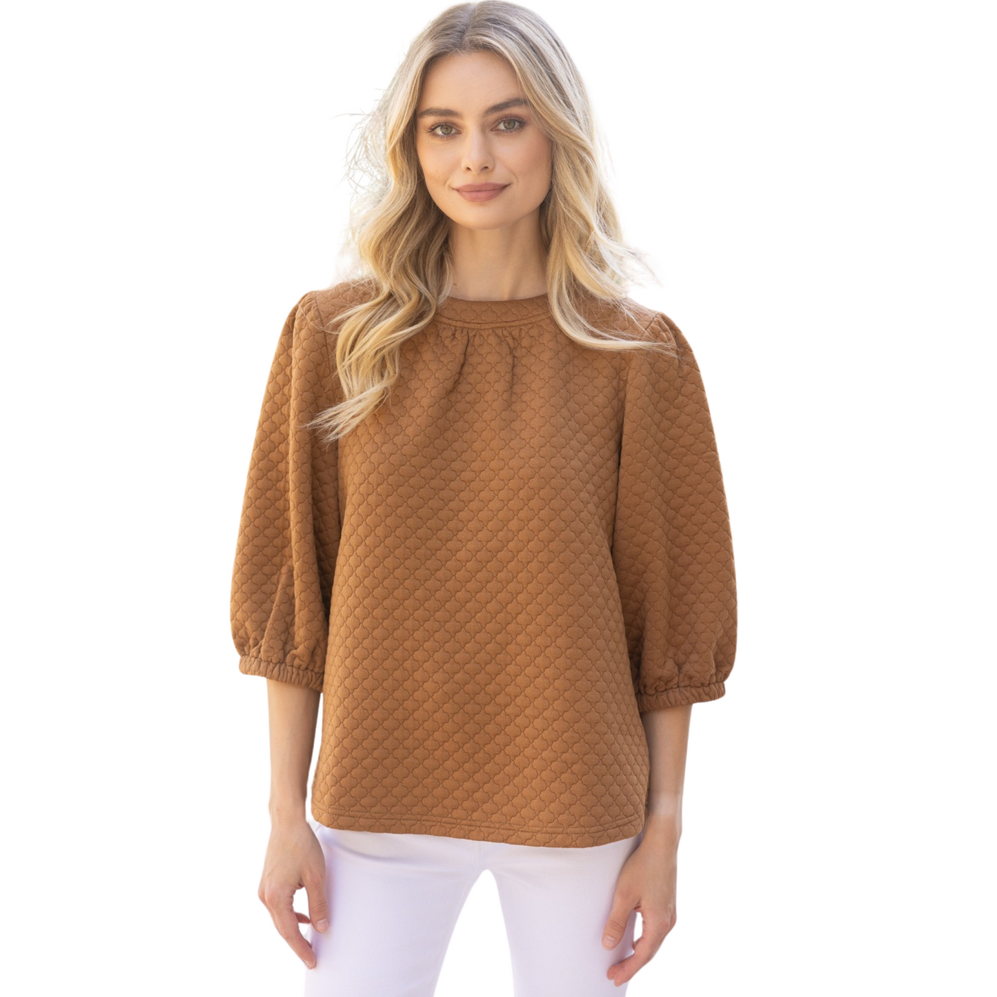 This quilted knit top features a round neckline with band and back neck button and elastic loop closure, paired with half puff sleeves for a fashionable and comfortable fit. In a warm camel color, this top is perfect for adding texture and style to any outfit.