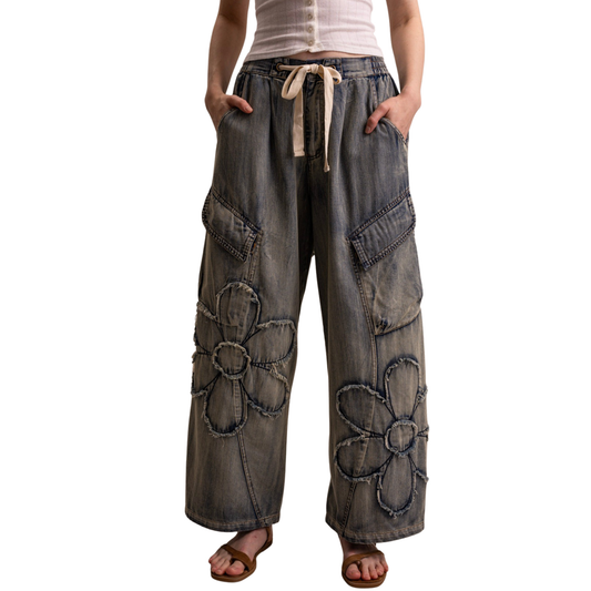 Effortless style meets comfort in these Blue Velvet Flower Cargo Denim Pants. Crafted from light denim, these baggy wide-leg pants feature a charming flower patchwork design that adds personality to any outfit. The adjustable drawstring waist ensures a perfect fit, while the relaxed silhouette provides all-day wearability. Perfect for casual days when you want to look put-together without sacrificing comfort.
