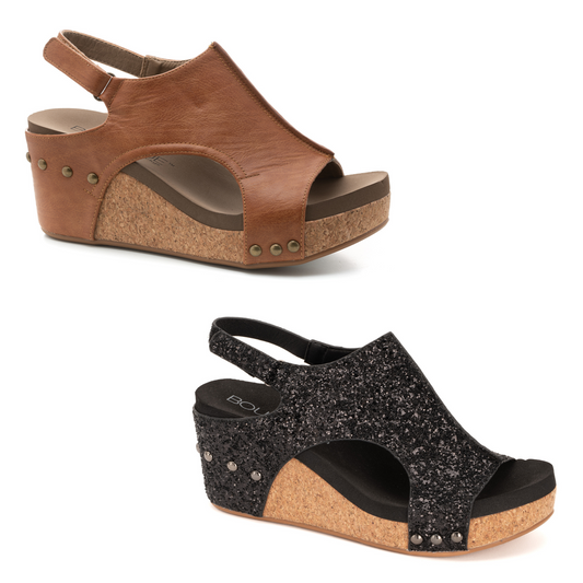 The Carley sandal wedge features an open toe design, adding a touch of sophistication to any outfit. Available in both cognac and black glitter, this versatile shoe is perfect for both casual and dressy occasions. Elevate your style with Carley.