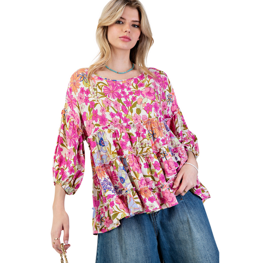 Introducing the Challis Ruffled Babydoll Top by easel. Experience ultimate comfort and style with 3/4 puff sleeves, tiered and ruffled bottom, and a flowy silhouette. Made with printed rayon challis fabric, this top features an allover flower print design for a relaxed and loose fit. Elevate your wardrobe with this must-have piece.