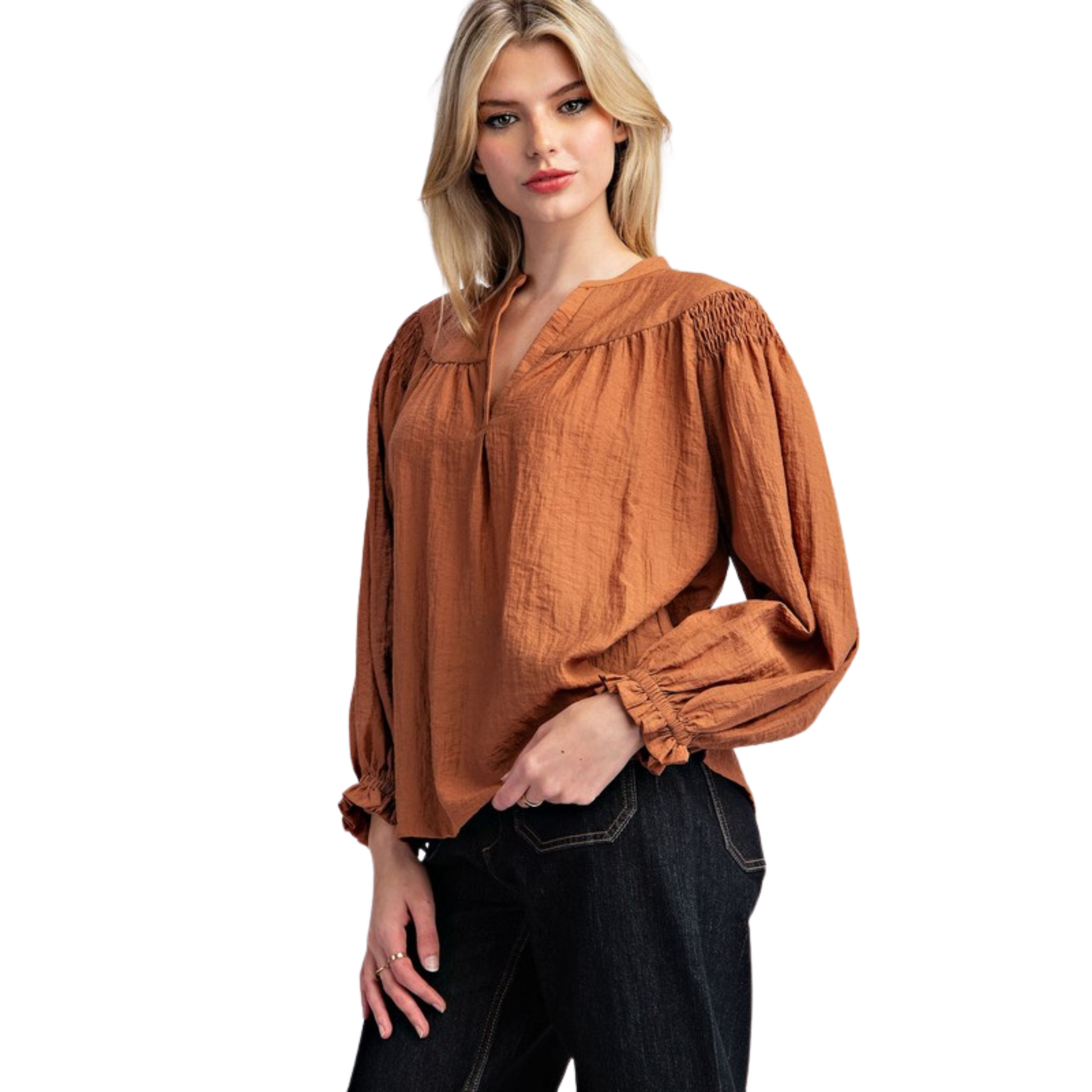 Solid long sleeve blouse top featuring a notched neckline, added seams and pinching for detail, smocked shoulders, elastic cuffs and is a lightweight material, perfect for transitioning seasons.