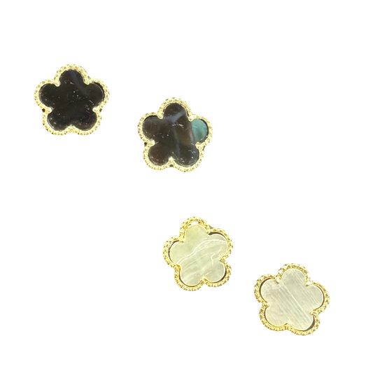 The Clover Studs are a sophisticated addition to any jewelry collection. Available in black or mother of pearl, these stud earrings feature a delicate clover design with elegant gold accents. Elevate any outfit with these timeless and versatile earrings.