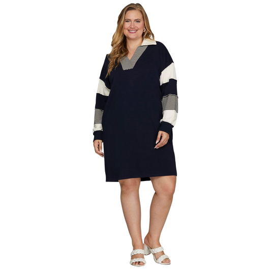 This Mad Fit plus size mini dress features a striking navy base with contrasting color block sleeves for a modern, stylish look. Designed for both comfort and practicality, it includes convenient pockets, making it ideal for day-to-night wear. Its tailored fit and contemporary design provide a versatile piece that elevates your wardrobe with subtle, confident flair.
