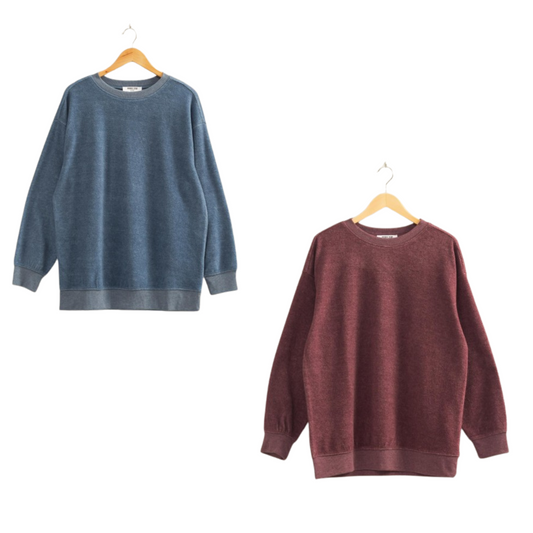 This oversized crewneck sweatshirt offers relaxed comfort with a casual aesthetic, available in sophisticated dark cherry or dusty navy hues. Its roomy fit ensures effortless layering, making it a versatile piece for everyday wear. Crafted to provide both style and ease, it complements a laid-back wardrobe while maintaining an elevated look.