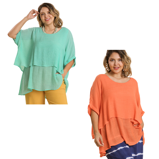 This cuffed sleeve tunic in a refreshing ice mint or tangerine color is perfect for all sizes. Its tiered design adds a stylish touch while the half sleeves provide comfort and coverage. A must-have for any wardrobe.