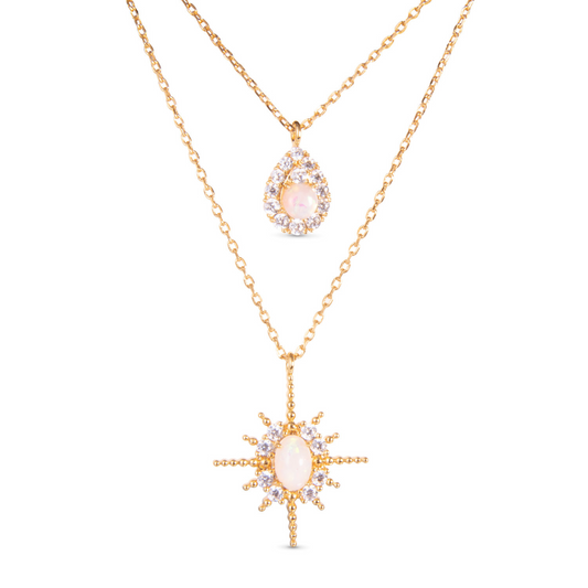 This Opal Double Necklace is a must-have for any jewelry lover. Made of gold and adorned with sparkling rhinestone accents, this necklace offers the perfect blend of elegance and style. Plus, with the unique design of having two necklaces in one, you can mix and match to create your own unique look. Add this versatile piece to your collection today.