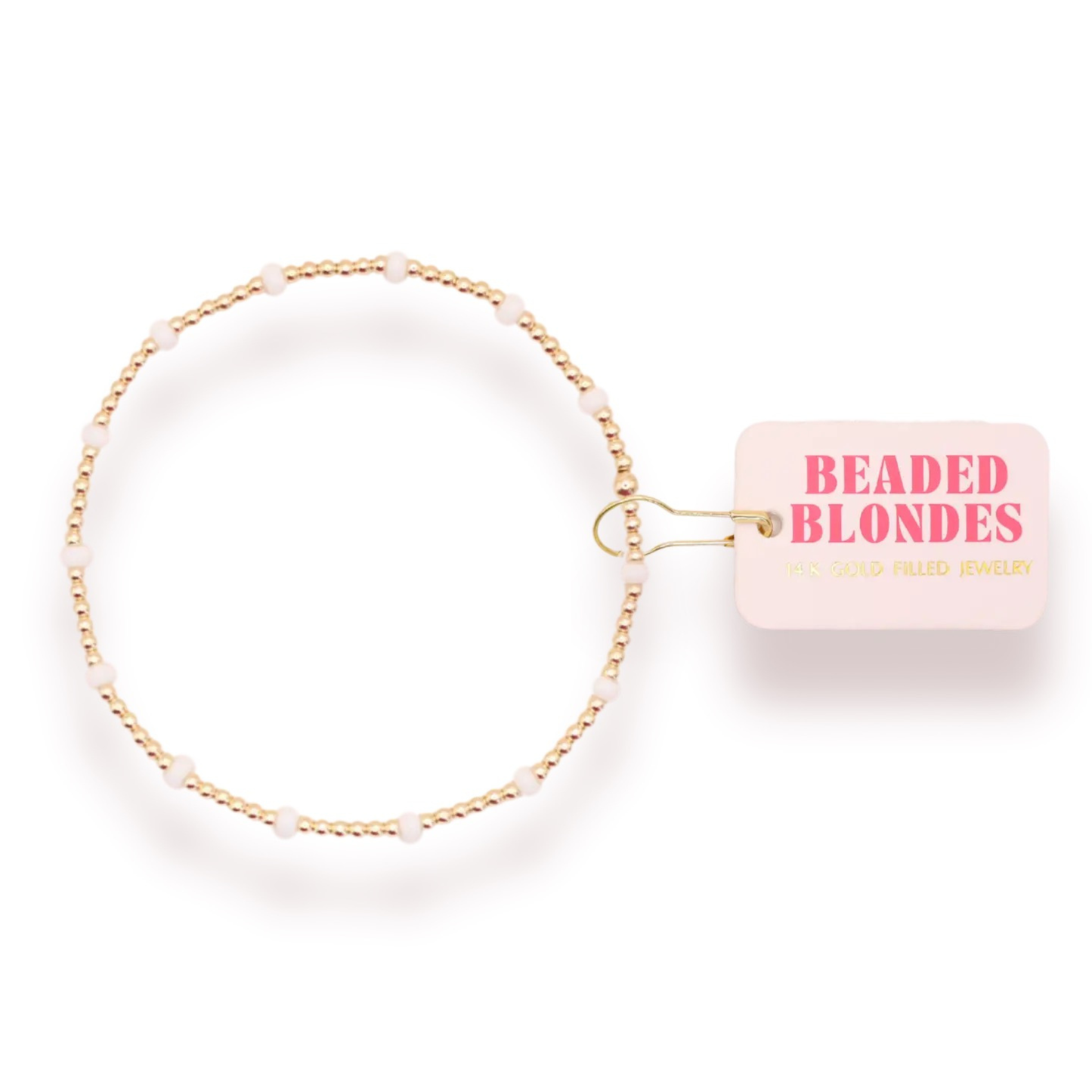 Elevate your everyday style with the Dainty Poppi Bracelet from Beaded Blondes. This delicate stretchy bracelet features lustrous white and gold beads that catch the light beautifully, creating an effortless sophisticated look. The comfortable stretch fit adapts to your wrist, making it perfect for layering or wearing solo. A timeless piece that transitions seamlessly from casual to dressed-up occasions.