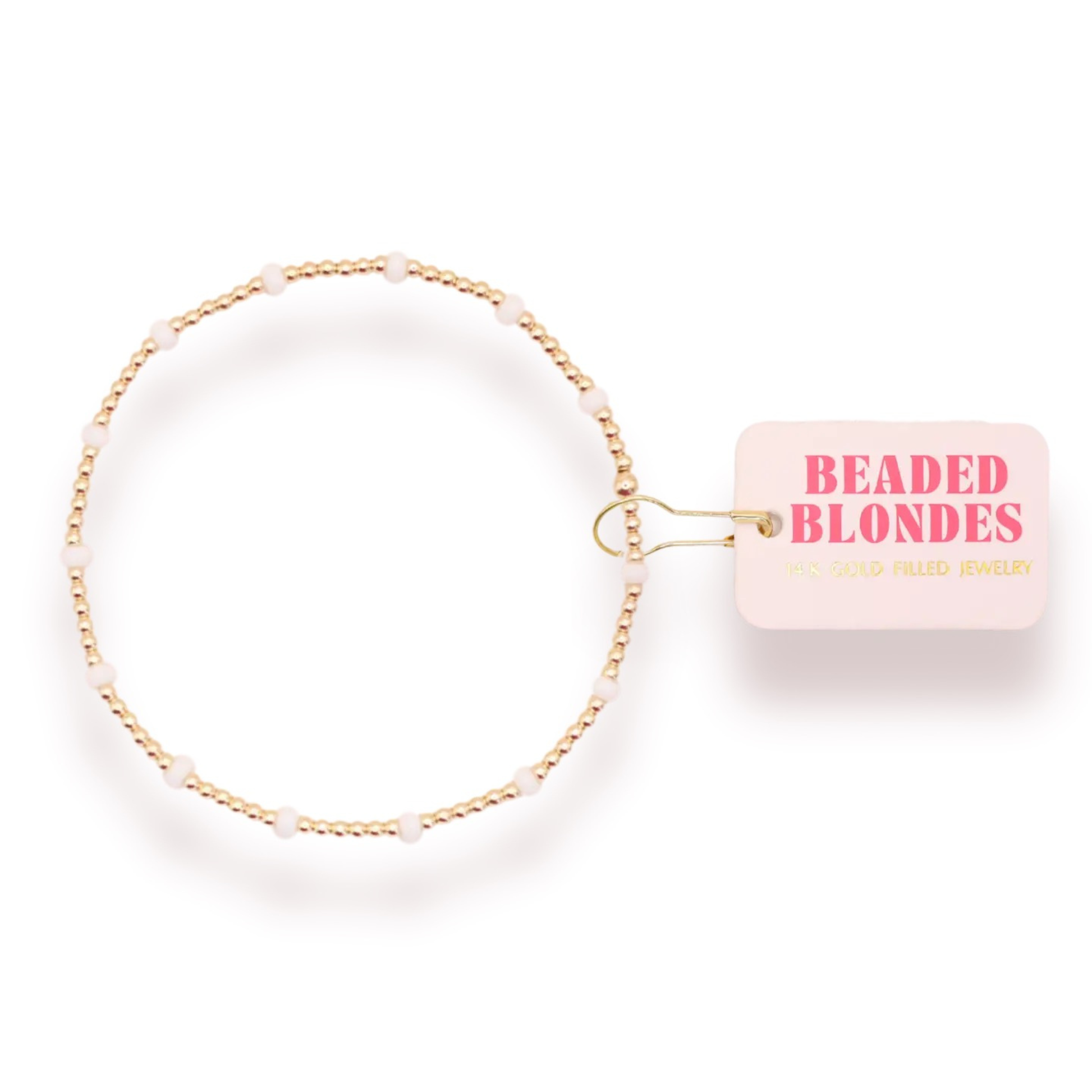 Elevate your everyday style with the Dainty Poppi Bracelet from Beaded Blondes. This delicate stretchy bracelet features lustrous white and gold beads that catch the light beautifully, creating an effortless sophisticated look. The comfortable stretch fit adapts to your wrist, making it perfect for layering or wearing solo. A timeless piece that transitions seamlessly from casual to dressed-up occasions.