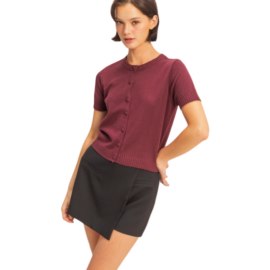 This Double Zero short sleeve button-down cardigan in dark cherry offers a refined blend of style and comfort. Its tailored fit and rich color make it an ideal choice for layering or wearing on its own, providing a polished look suitable for various occasions.