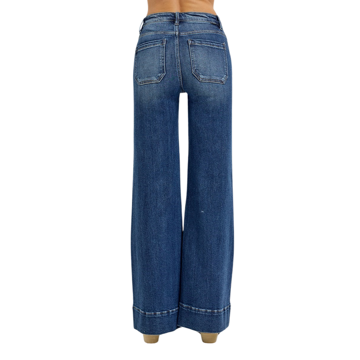 Crafted by Risen, these High Rise Flare Jeans in a deep dark wash offer a sophisticated silhouette with their wide-leg cut that elongates the legs. The high-rise design ensures a flattering fit around the waist, while the patch pocket detailing adds a contemporary, functional touch. Ideal for those seeking a blend of classic denim style and modern tailoring, these jeans provide both comfort and a polished look for versatile wear.